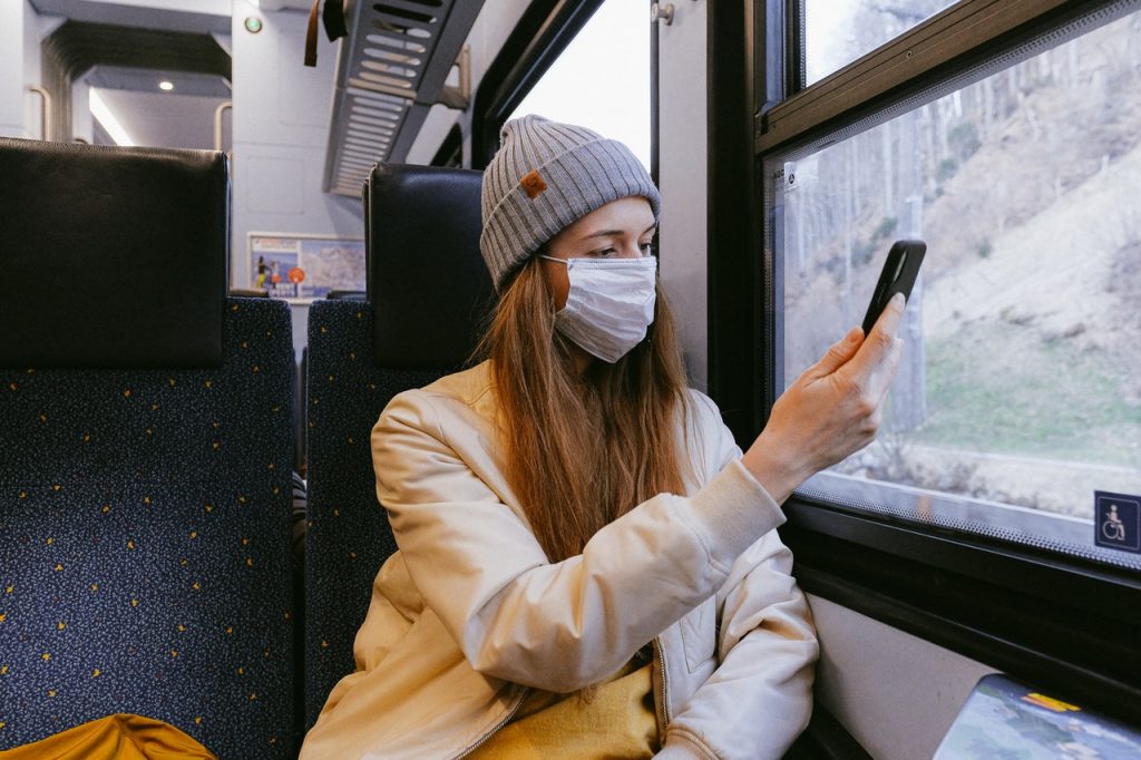 Woman using mask on a bus