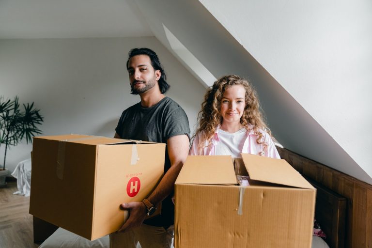 Man and woman holding boxes