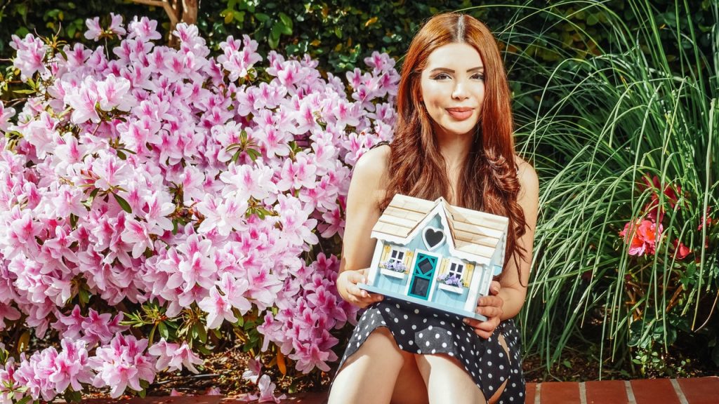 Woman holding a little house